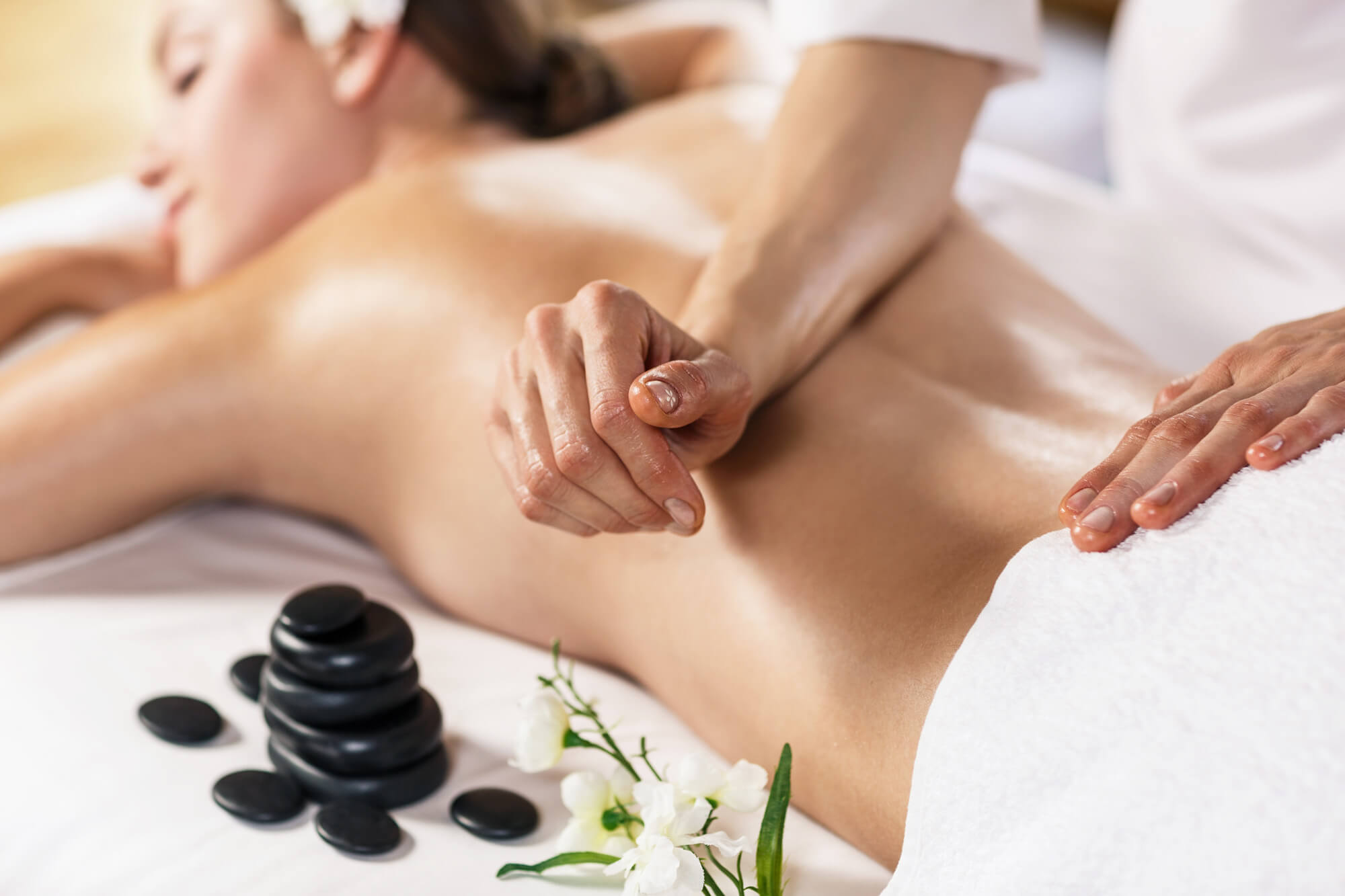 Woman getting massage with hot stones
