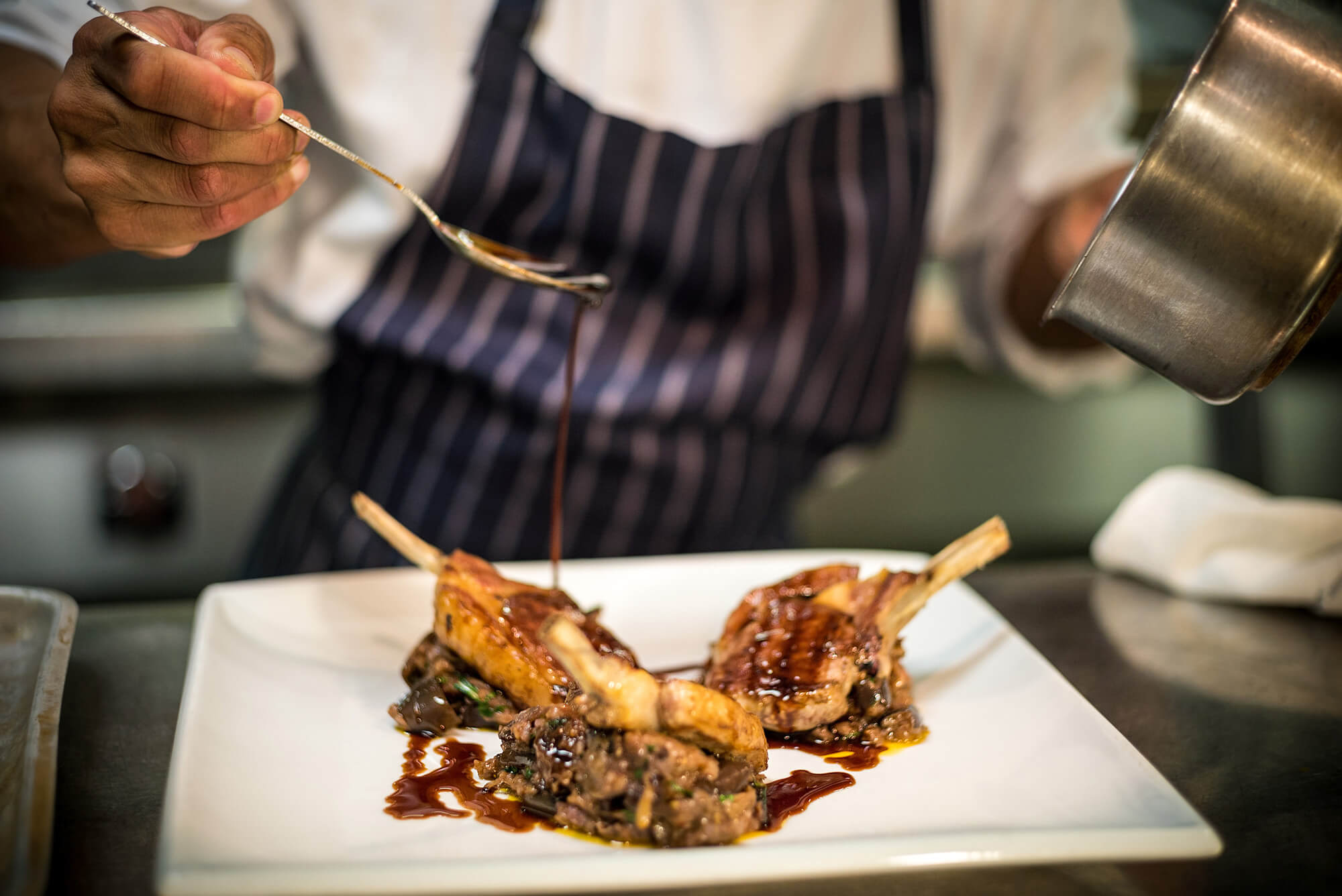 Chef plating up food on a plate
