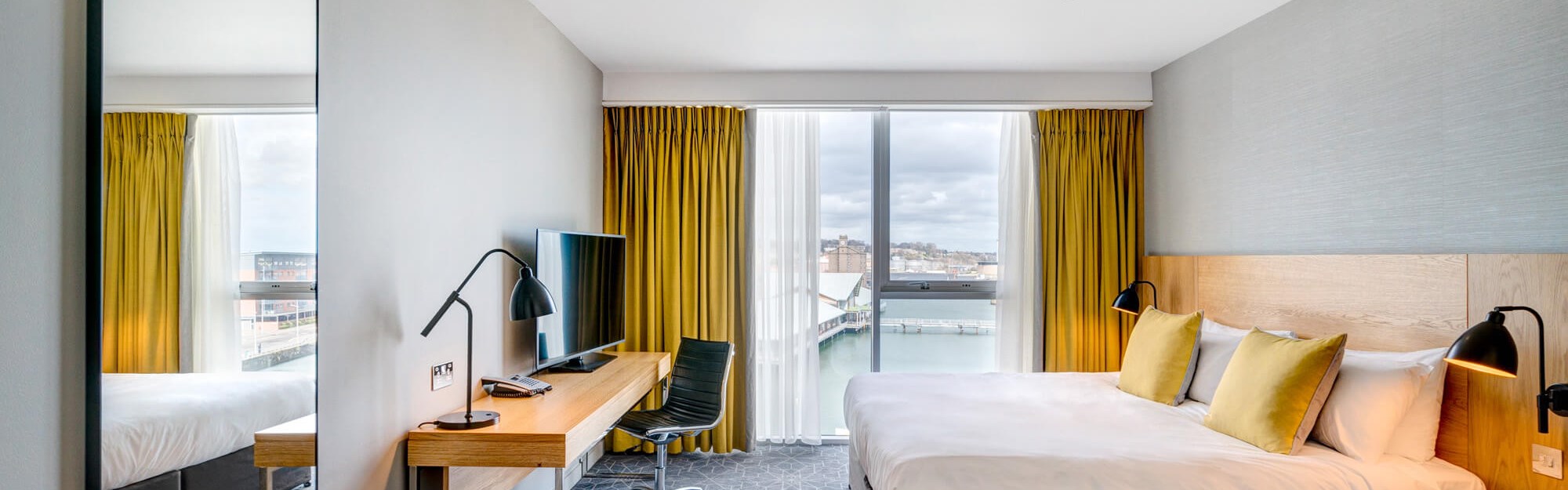 King size bed, desk and views looking out to the city quay