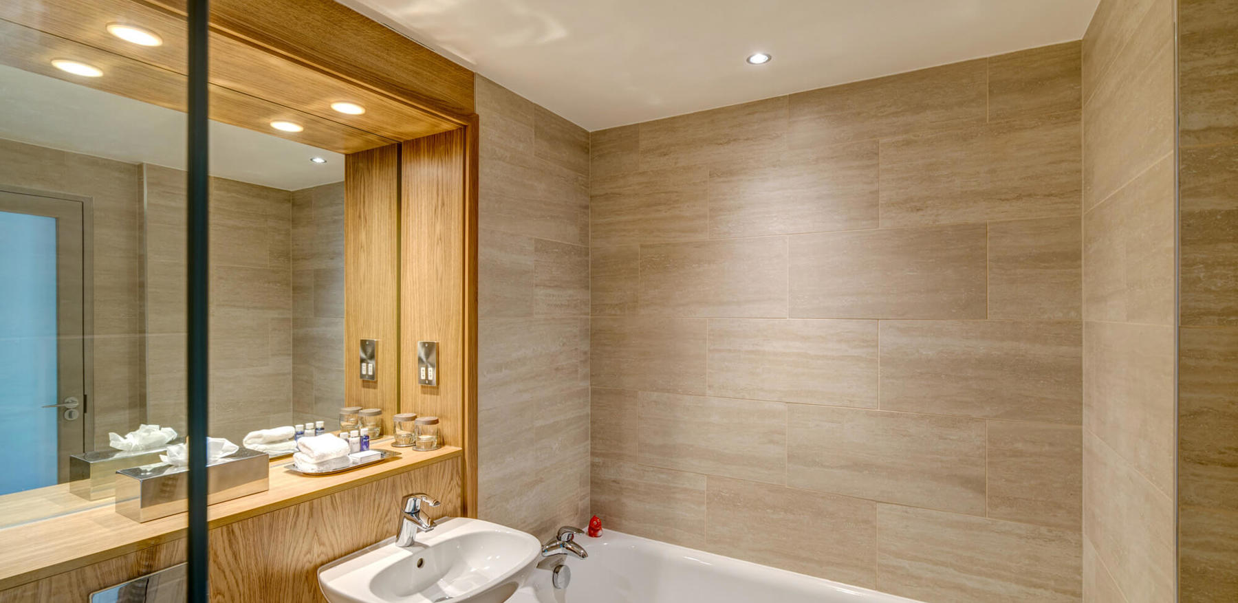 Bath tub next to sink in bathroom