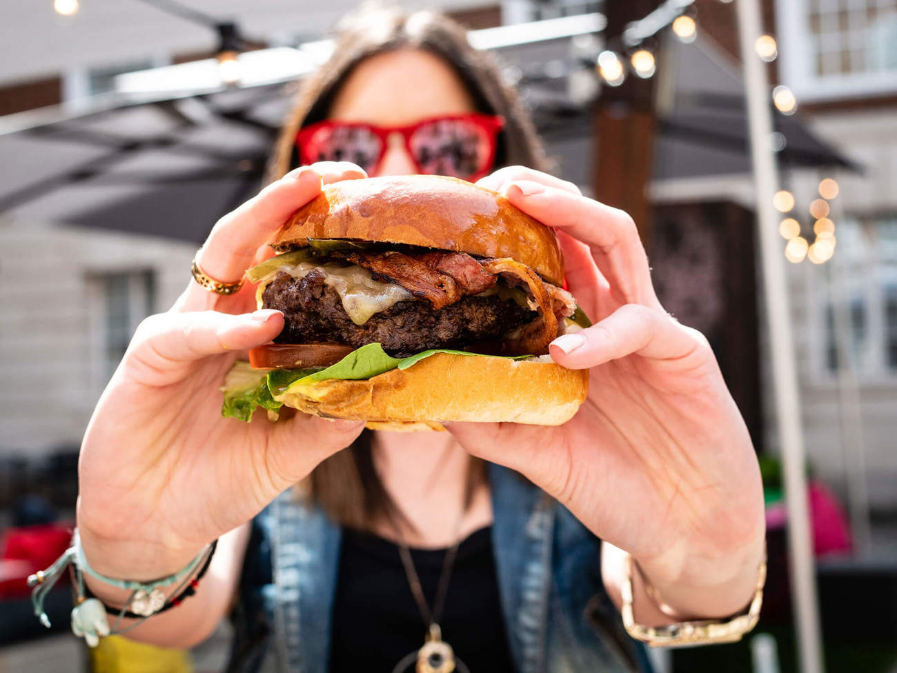 Street food in Glasgow Woman wearing sunglasses holding burger
