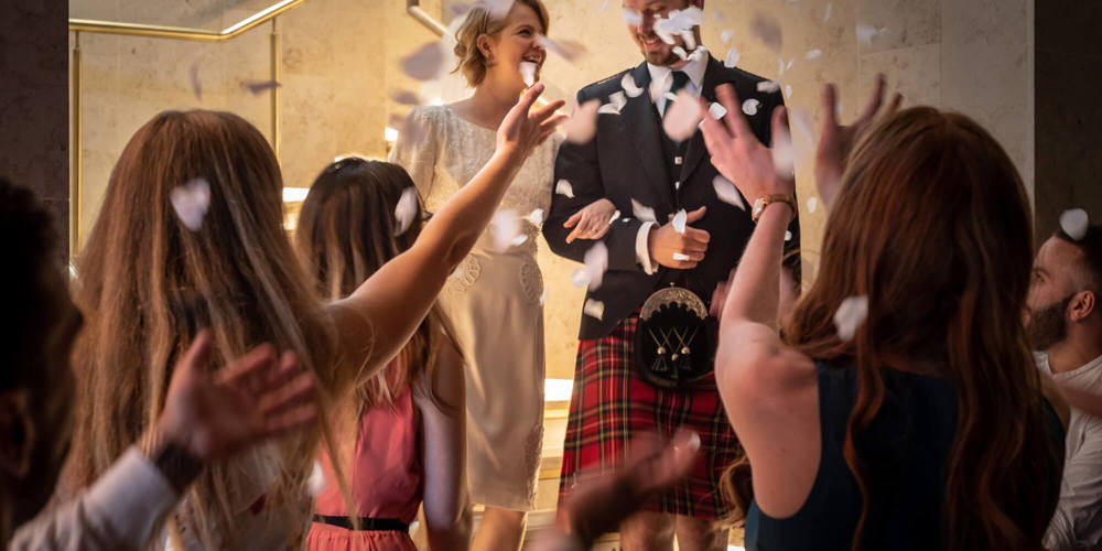 Celebrations at Apex Hotels Newly married couple with crowd throwing confetti