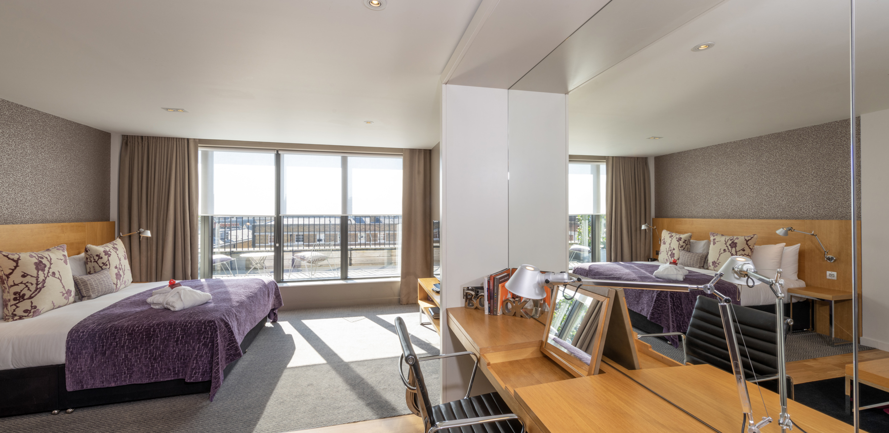 Bedroom area with bed and TV in Junior Suite with Balcony at Apex Temple Court Hotel