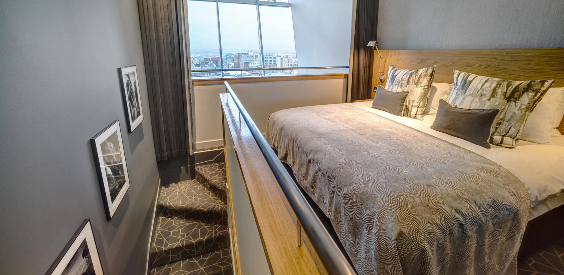 Duplex Suite bedroom with large bed and stairs