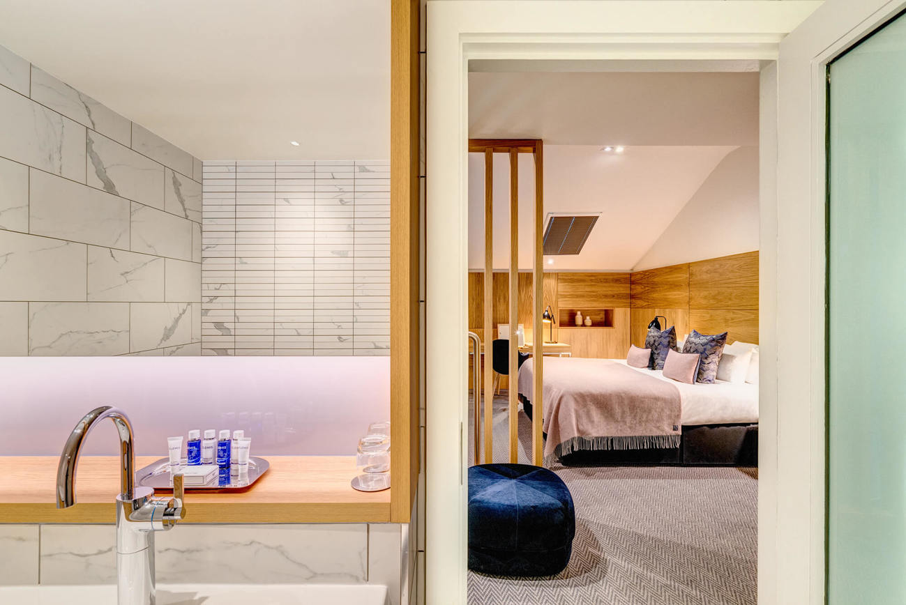 Duplex Suite bathroom and bedroom at Apex Waterloo Place Hotel Upstairs with marble bathroom and bedroom in Duplex Suite at Apex Waterloo Place Hotel