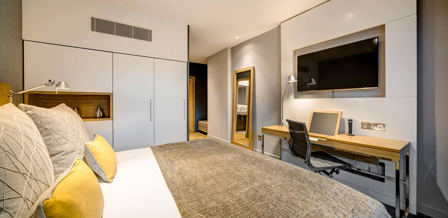 King-size bed with TV and desk area