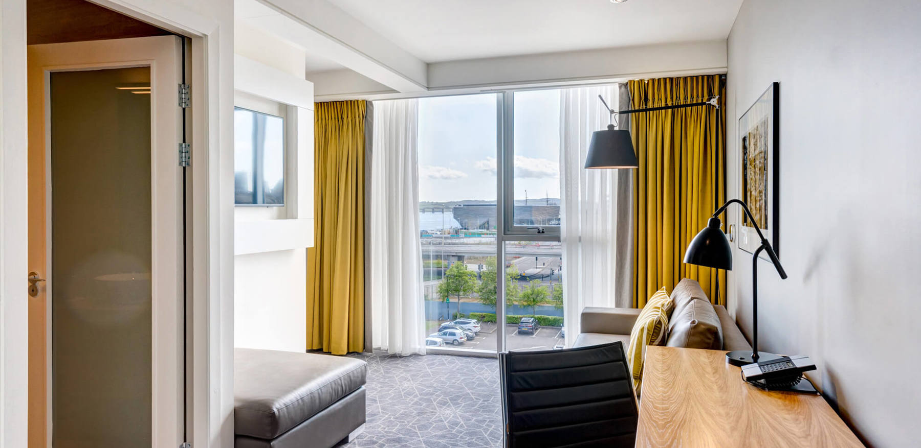 Junior Suite at Apex City Quay Hotel & Spa Junior Suite living area with sofa and TV