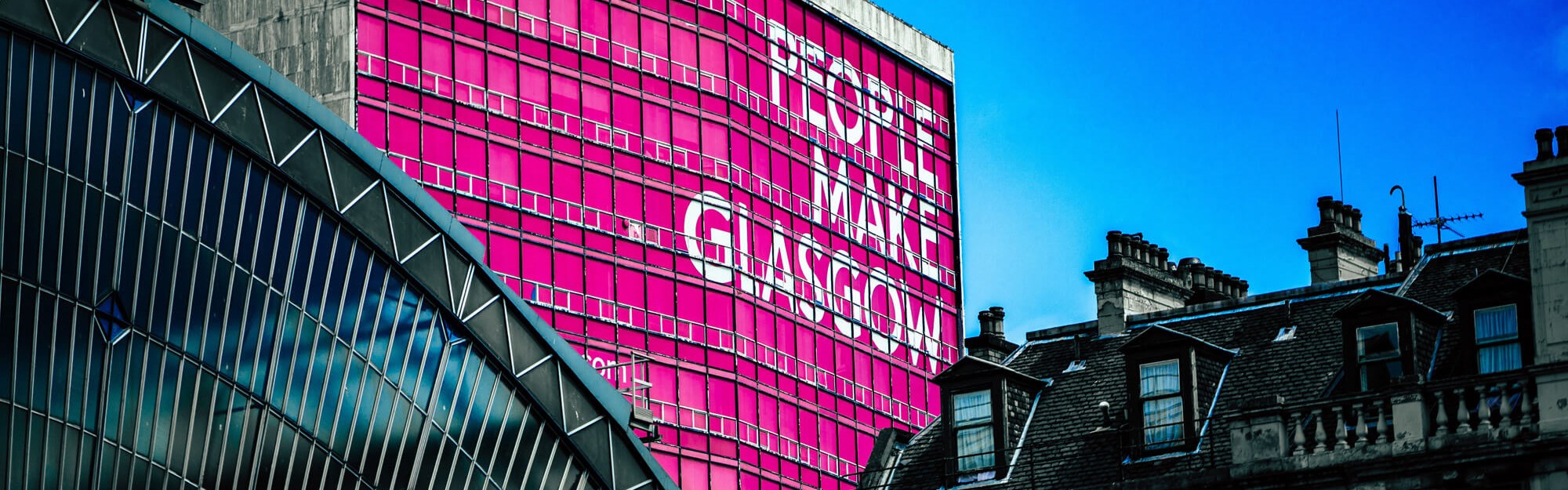 People make Glasgow sign on side of building