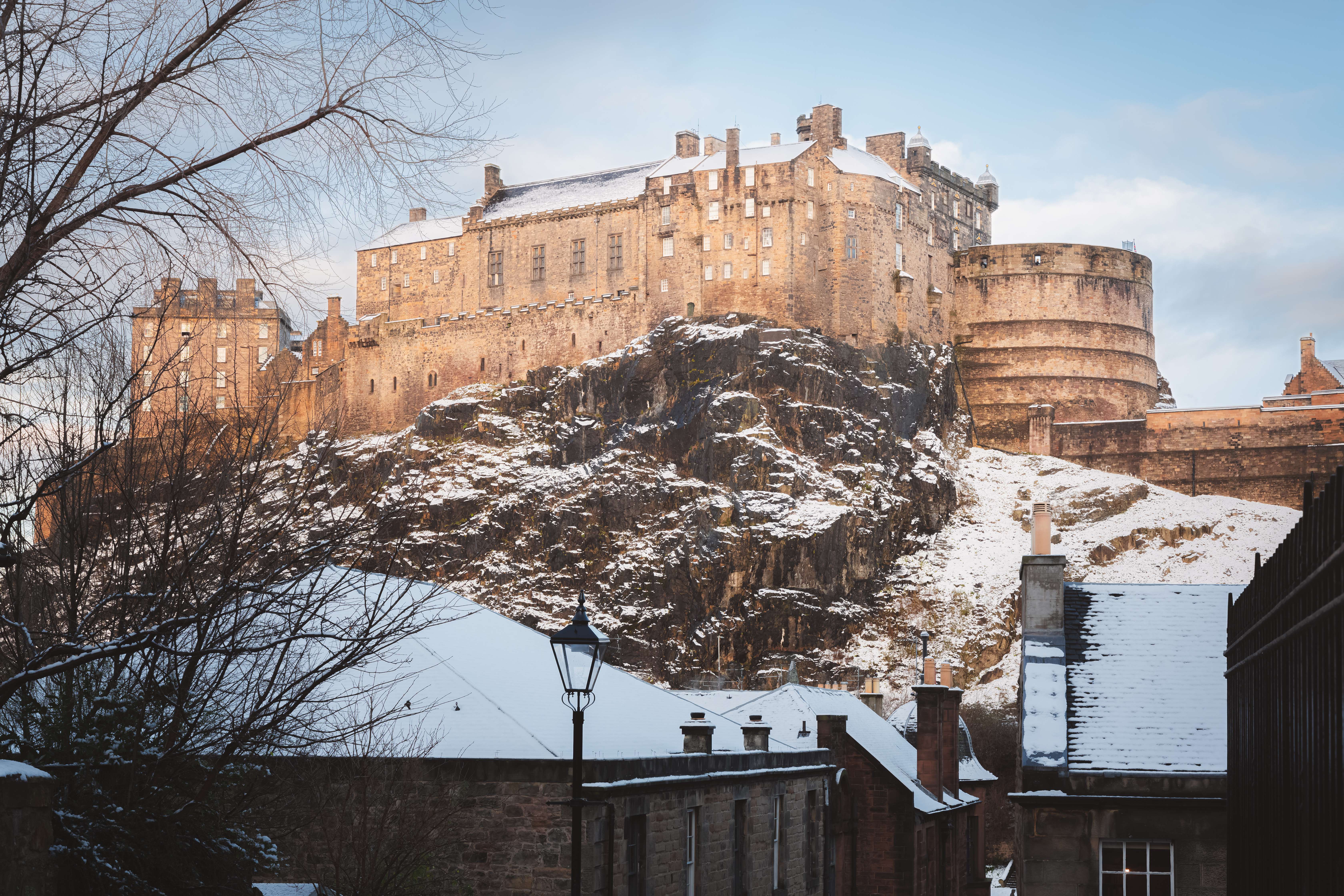 View of snowy Edinburgh castle from Apex Grassmarket