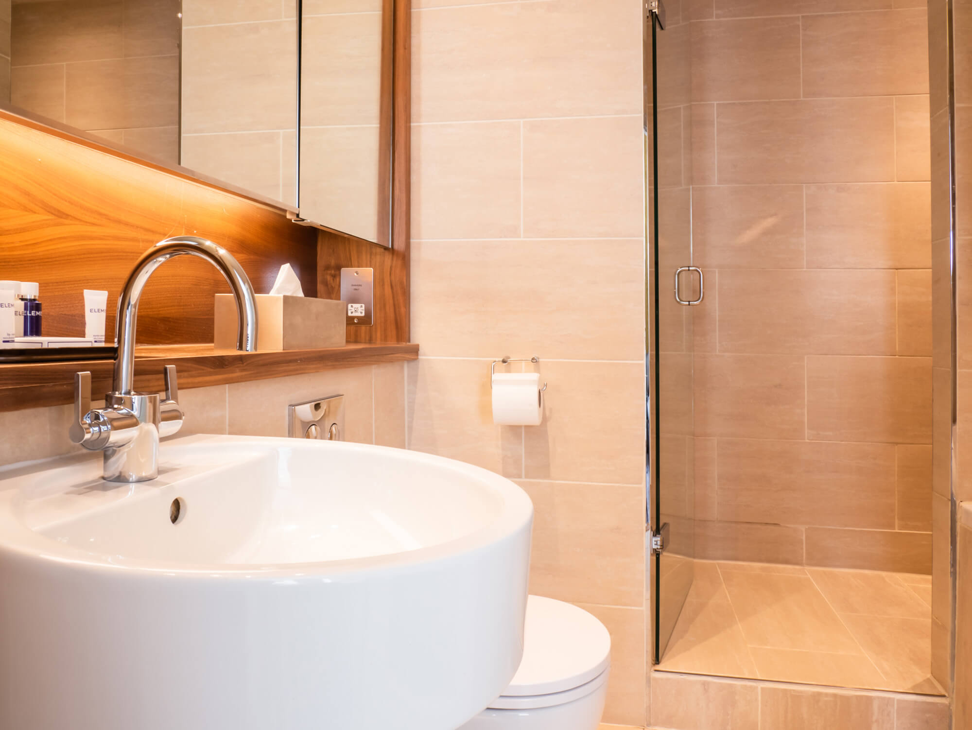Family Room bathroom sink and walk-in shower at Apex Waterloo Place Hotel