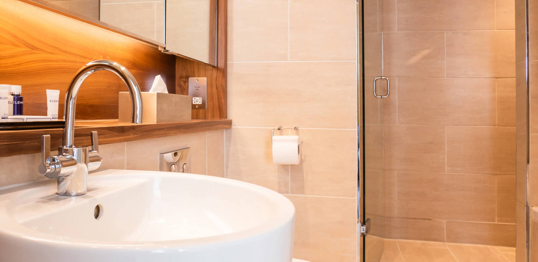 Family Room bathroom sink and walk-in shower at Apex Waterloo Place Hotel