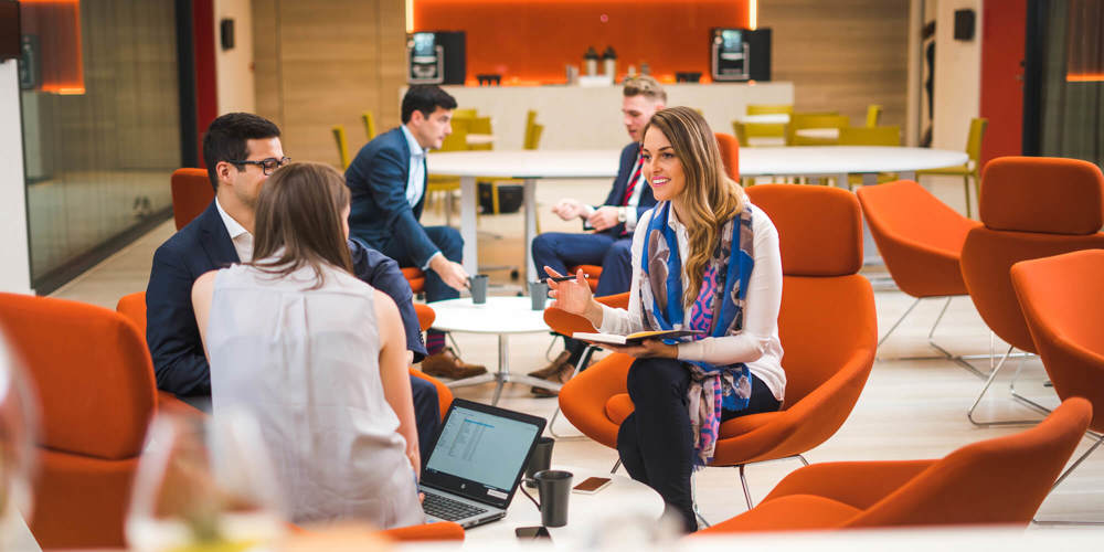 Colleagues sitting down chatting in The Atrium in Apex City of Bath Hotel Hotels with meeting rooms