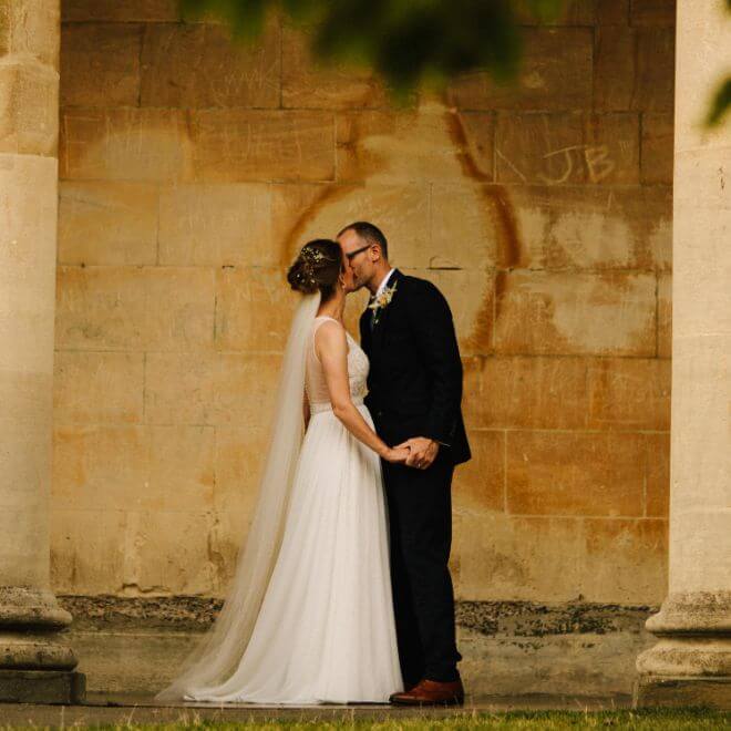 Couple Kissing In Front Of Old Style Building