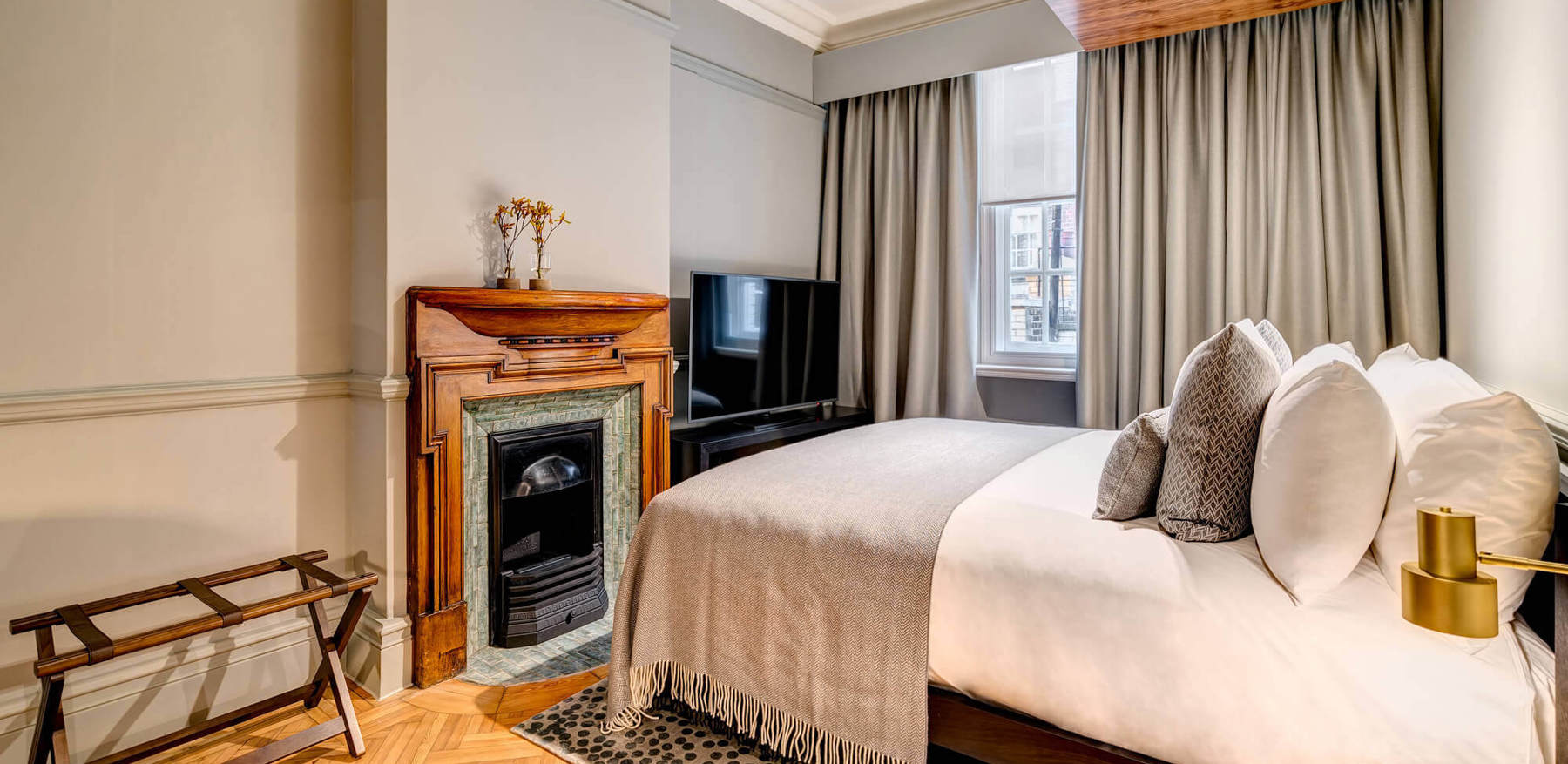 Grand Suite bedroom with fireplace at Apex Temple Court Hotel