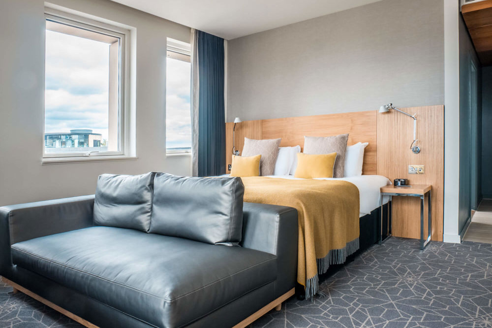 Deluxe Room at Apex Waterloo Place Hotel Deluxe Room with king-size bed and sofa at Apex Waterloo Place Hotel