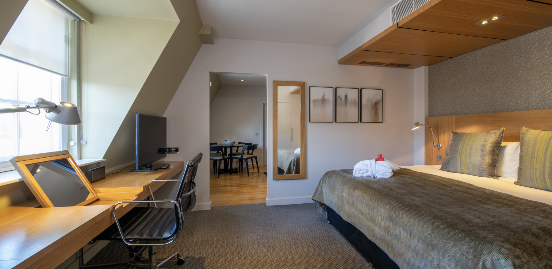 Master Suite bedroom with bed and desk at Apex Temple Court Hotel