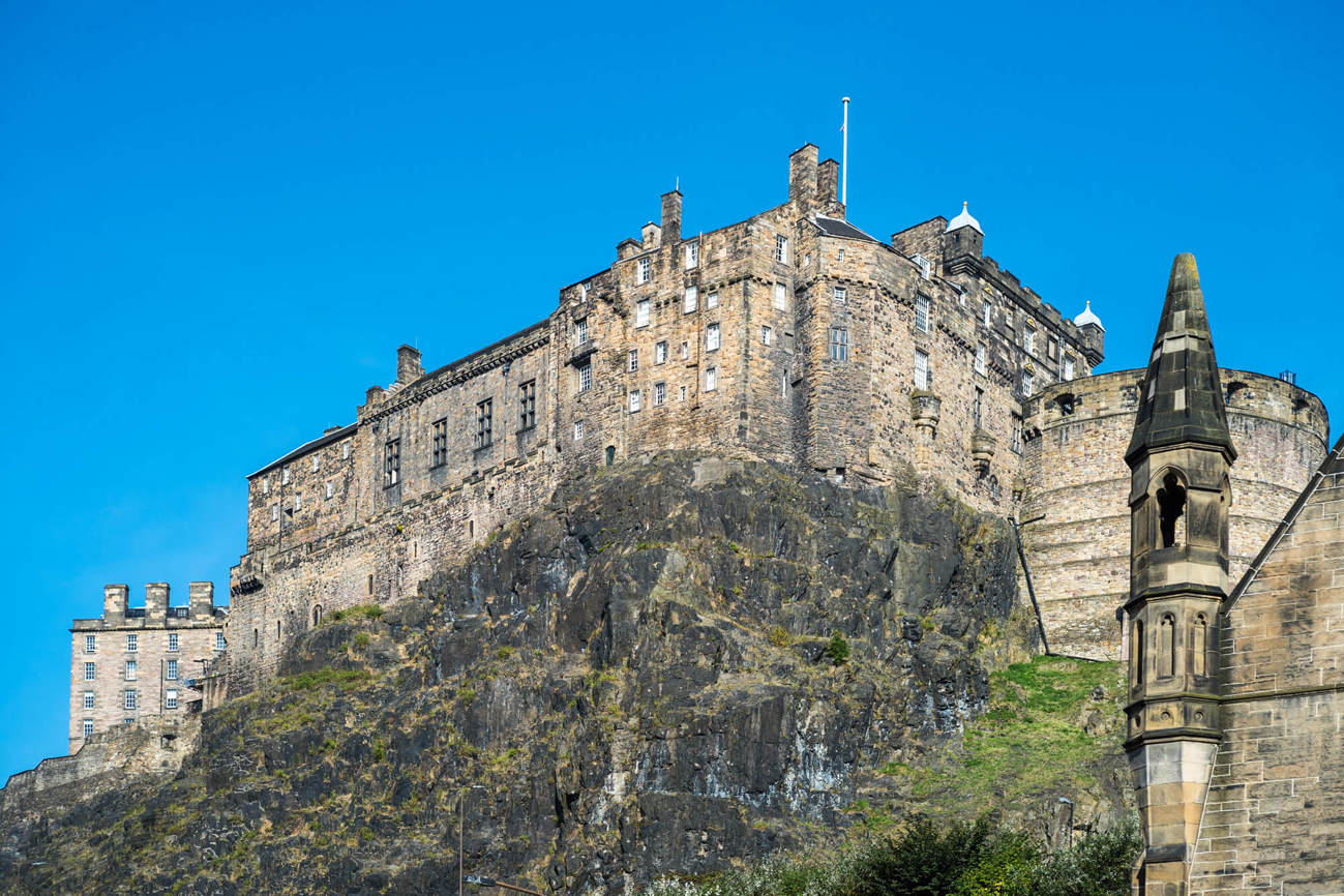 Edinburgh Castle Edinburgh Castle against backdrop of blue sky during the day