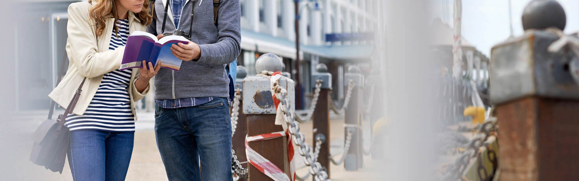 Explore new cities this winter Tourist couple looking at map