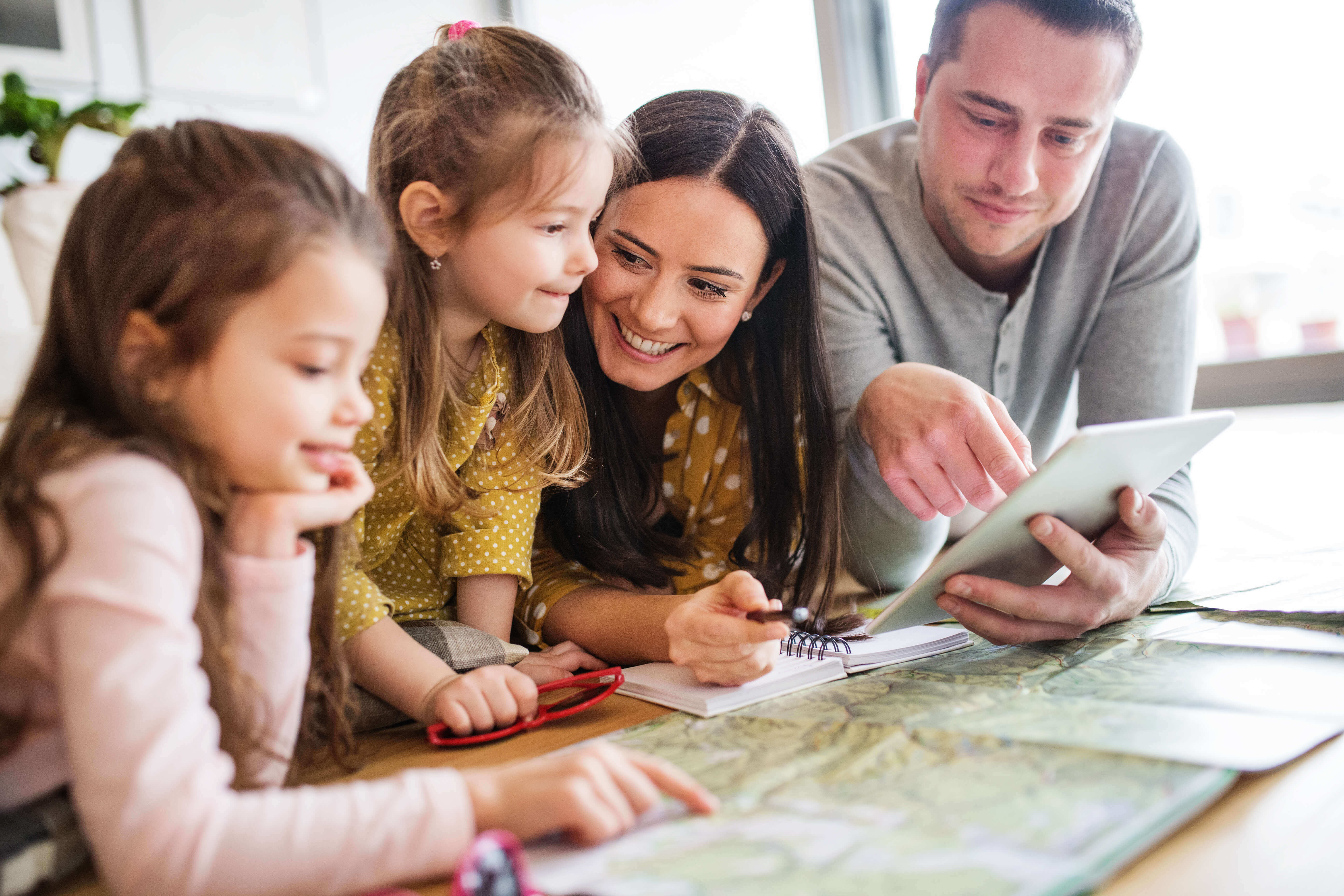 family pointing at a map