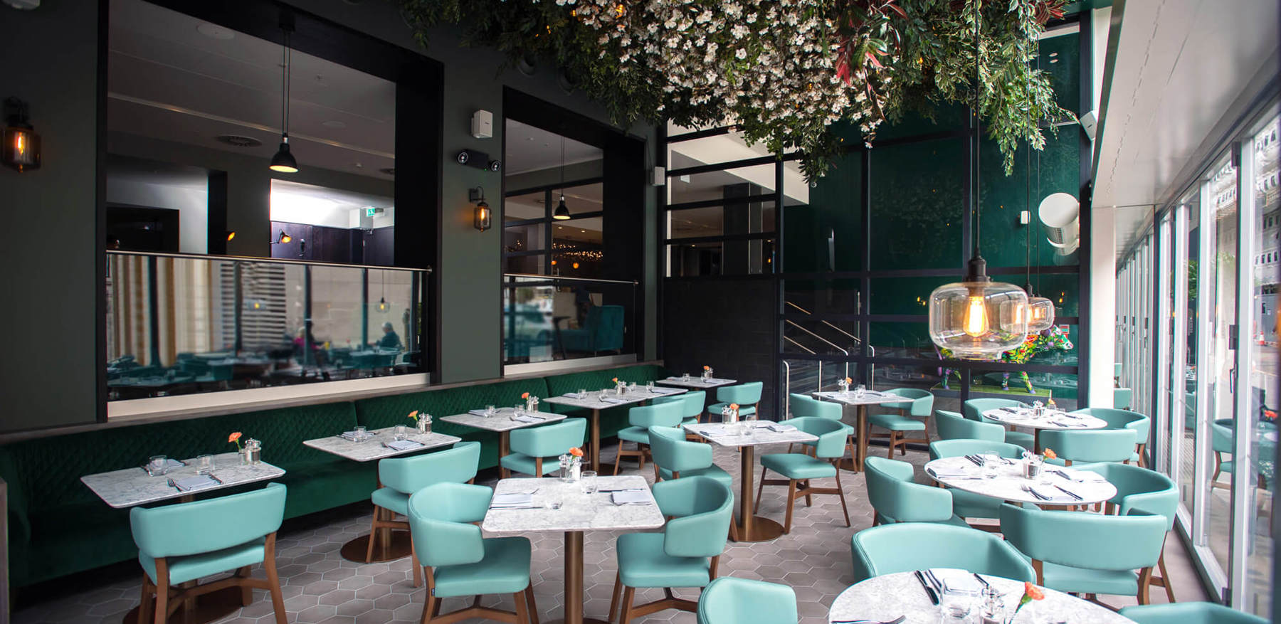 Inside Of Empty Restaurant With Floral Ceiling Decor & Blue Interior Inside Of Empty Restaurant With Floral Ceiling Decor & Blue Interior