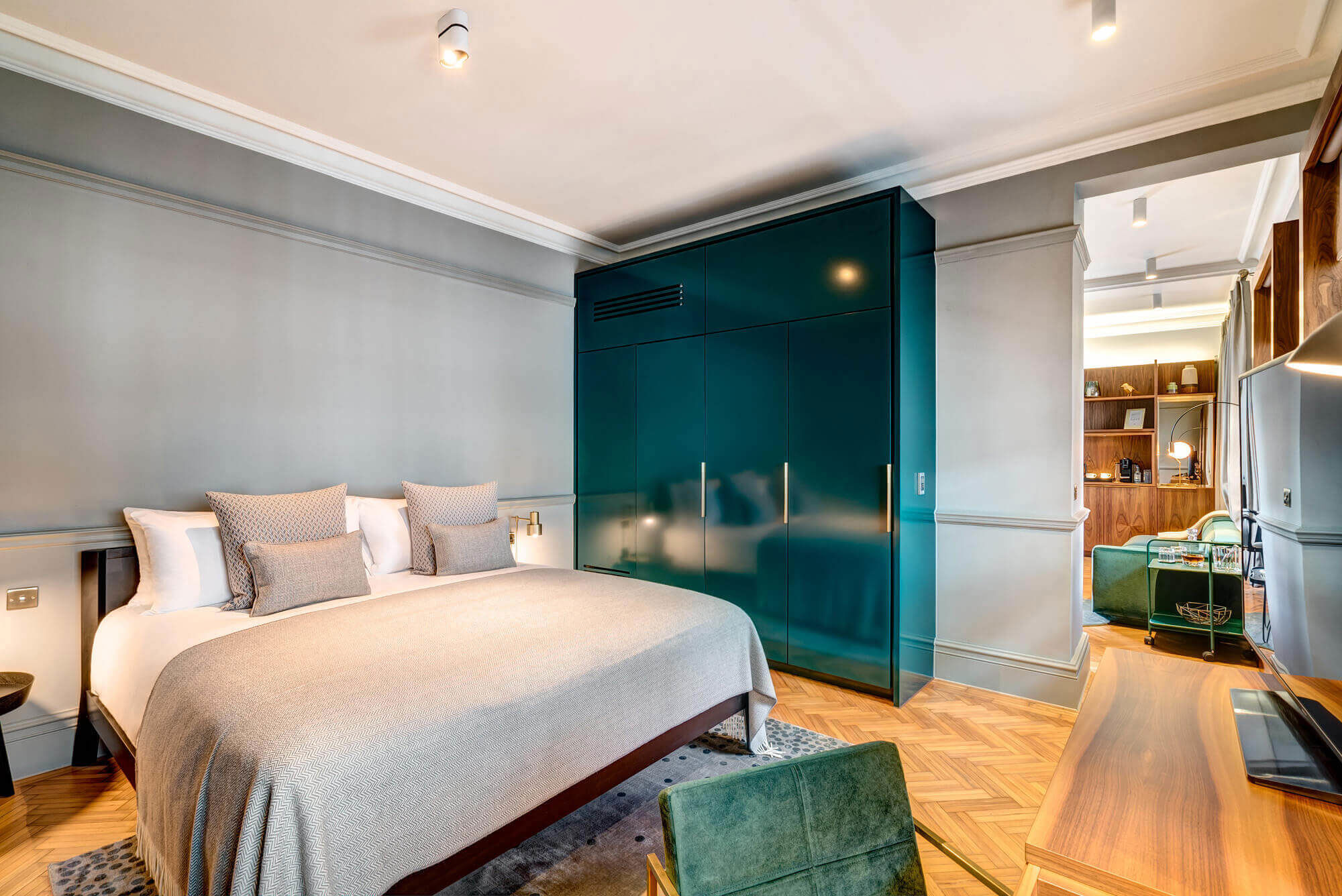 Grand Suite bedroom featuring a Queen size bed looking into separate living area at Apex Temple Court Hotel